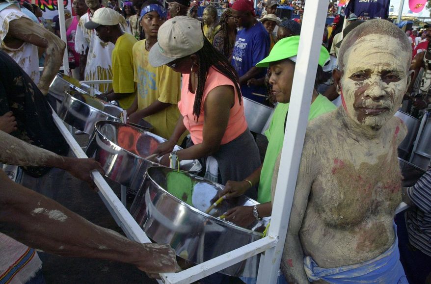 FILE -Steelpan players perform during J'Ouvert carnival celebrations in Port-of-Spain, Trinidad, Feb. 7, 2005. (AP Photo/Andres Leighton, File)
