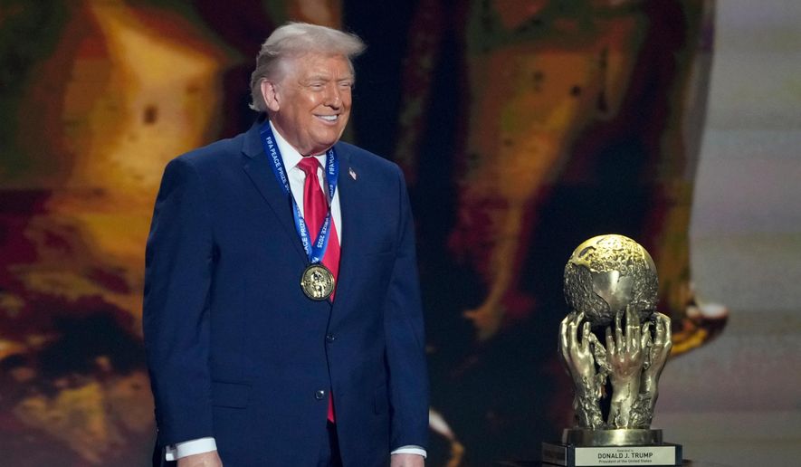 President Donald Trump smiles after being awarded the FIFA Peace Prize during the draw for the 2026 soccer World Cup at the Kennedy Center in Washington, Friday, Dec. 5, 2025. (AP Photo/Chris Carlson)