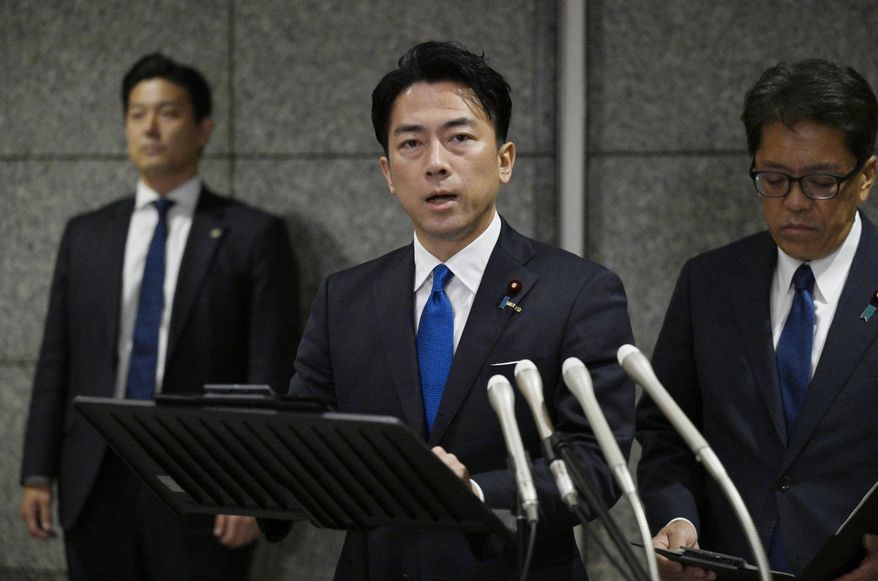 Japan's Defense Minister Shinjiro Koizumi, center, speaks to the media, as Japan announced that a Chinese military aircraft locked its radar on Japanese jets, at the ministry in Tokyo, Sunday, Dec. 7, 2025. (Kyodo News via AP) ** FILE **