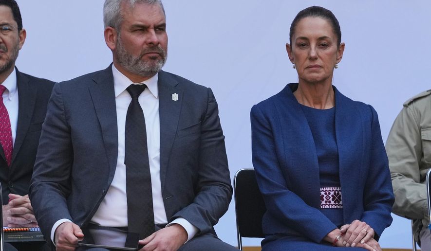 Michoacán State Governor Alfredo Ramirez Bedolla, left, and Mexican President Claudia Sheinbaum attend a presentation of the new security strategy against violence for the state of Michoacan, at the National Palace in Mexico City, Nov. 9, 2025. (AP Photo/Claudia Rosel, File)