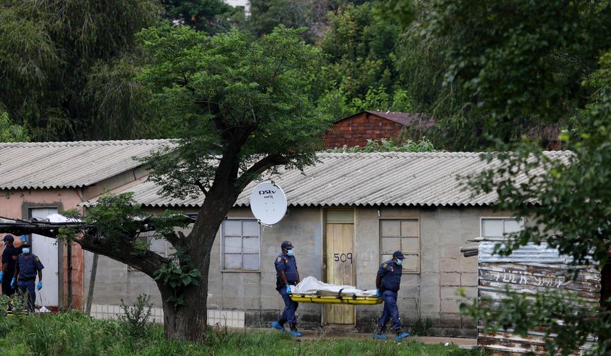 Police officers carry the body of a person on a stretcher after a mass shooting at a bar near Pretoria, South Africa, Saturday, Dec. 6, 2025. (AP Photo)
