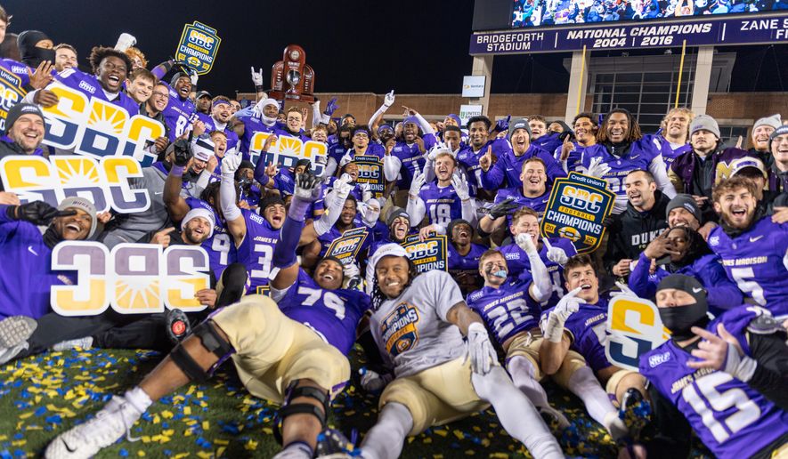 James Madison team celebrates after winning the Sun Belt championship NCAA college football game against Troy, Friday, Dec. 5, 2025, in Harrisonburg, Va. (AP Photo/Robert Simmons)