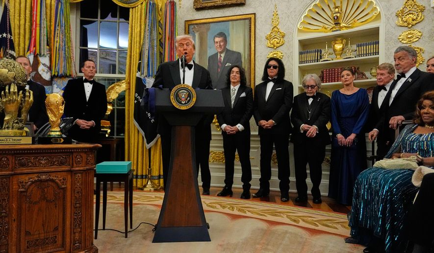 President Donald Trump, center, speaks as he presents Sylvester Stallone, George Strait, KISS, Gloria Gaynor and Michael Crawford with their Kennedy Center Honors medals in the Oval Office of the White House, Saturday, Dec. 6, 2025, in Washington. (AP Photo/Julia Demaree Nikhinson)