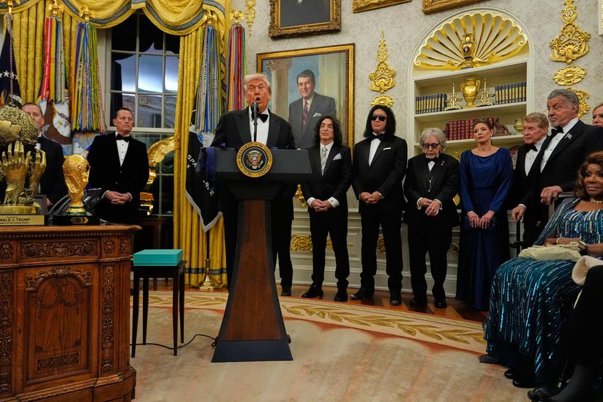 President Donald Trump, center, speaks as he presents Sylvester Stallone, George Strait, KISS, Gloria Gaynor and Michael Crawford with their Kennedy Center Honors medals in the Oval Office of the White House, Saturday, Dec. 6, 2025, in Washington. (AP Photo/Julia Demaree Nikhinson)