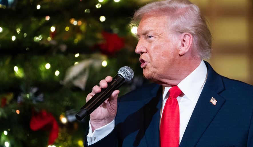 President Donald Trump speaks before a concert by Andrea Bocelli in the East Room of the White House walking towards the East Room, Friday, Dec. 5, 2025, in Washington. (AP Photo/Allison Robbert)