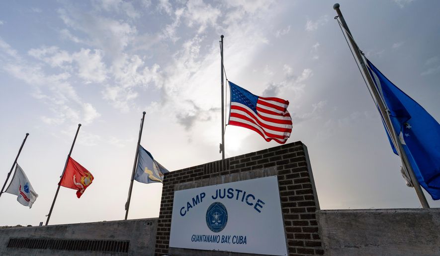 In this photo reviewed by U.S. military officials, flags fly at half-staff at Camp Justice, Aug. 29, 2021, in Guantanamo Bay Naval Base, Cuba. (AP Photo/Alex Brandon, File)