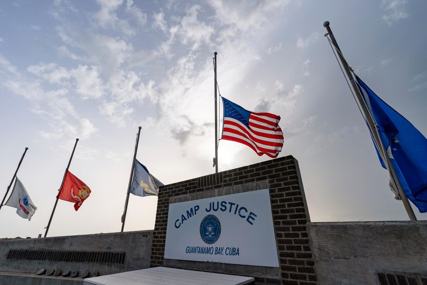 In this photo reviewed by U.S. military officials, flags fly at half-staff at Camp Justice, Aug. 29, 2021, in Guantanamo Bay Naval Base, Cuba. (AP Photo/Alex Brandon, File)