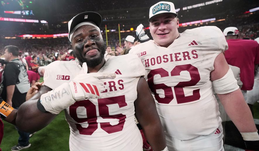 Indiana's Tyrique Tucker and Drew Evans celebrate after the Big Ten championship NCAA college football game against Ohio State in Indianapolis, Saturday, Dec. 6, 2025. (AP Photo/AJ Mast)