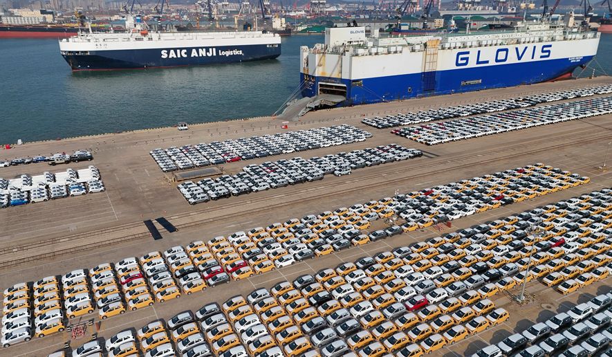 Vehicles and trucks for export wait for transportation from a port in Yantai in eastern China's Shandong province on Jan. 2, 2025. (Chinatopix via AP, File)