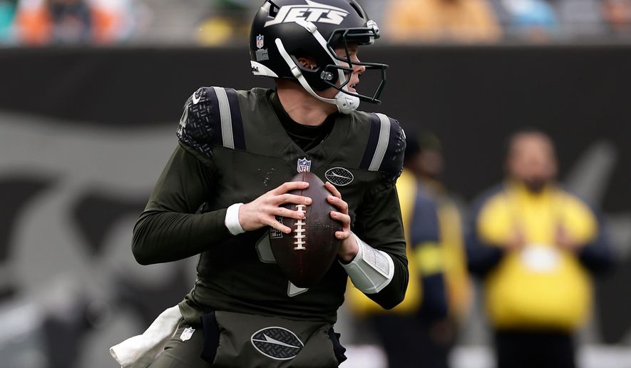 New York Jets quarterback Brady Cook (4) looks to pass against the Miami Dolphins during the second quarter of an NFL football game, Sunday, Dec. 7, 2025, in East Rutherford, N.J. (AP Photo/Adam Hunger)