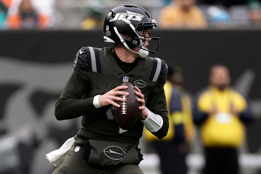 New York Jets quarterback Brady Cook (4) looks to pass against the Miami Dolphins during the second quarter of an NFL football game, Sunday, Dec. 7, 2025, in East Rutherford, N.J. (AP Photo/Adam Hunger)