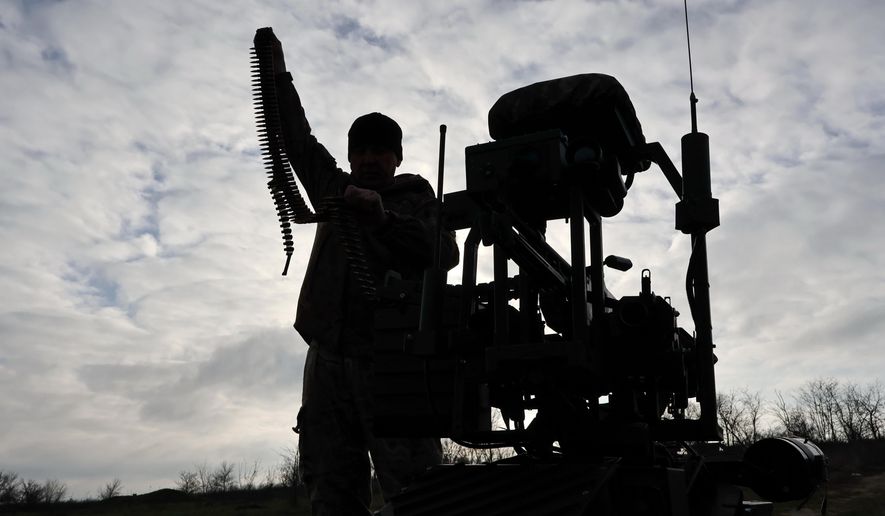 In this photo, provided by Ukraine's 65th Mechanized Brigade press service, a soldier tests land drones in Zaporizhzhia region, Ukraine, Saturday, Dec. 6, 2025, (Andriy Andriyenko/Ukraine's 65th Mechanized Brigade via AP)