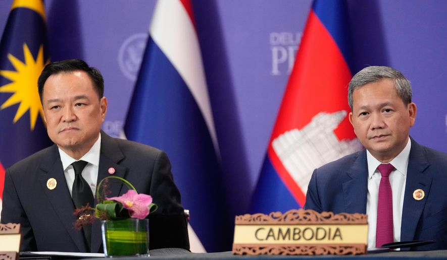 FILE - Cambodian Prime Minister Hun Manet, right, and Thailand's Prime Minister Anutin Charnvirakul, left, react during a signing ceremony on the sidelines of the ASEAN Summit in Kuala Lumpur, Malaysia, Sunday, Oct. 26, 2025. (AP Photo/Mark Schiefelbein, File)