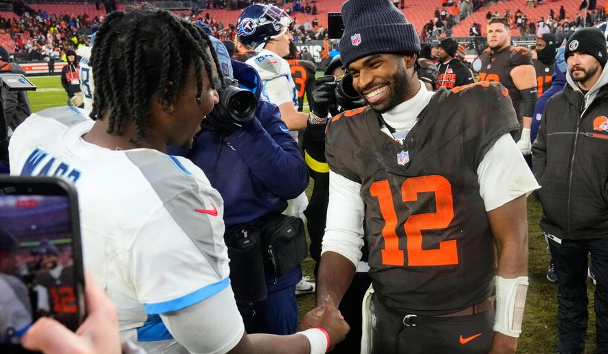 Tennessee Titans quarterback Cam Ward, left, and Cleveland Browns quarterback Shedeur Sanders (12) greet each other after an NFL football game in Cleveland, Sunday, Dec. 7, 2025. (AP Photo/Sue Ogrocki)