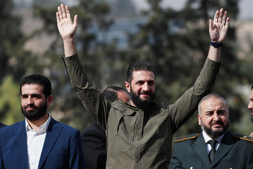 Syria's interim president, Ahmad al-Sharaa, greets people as he attends celebrations marking the first anniversary of the ousting of former President Bashar Assad in Damascus, Syria, Monday, Dec. 8, 2025. (AP Photo/Omar Sanadiki) I