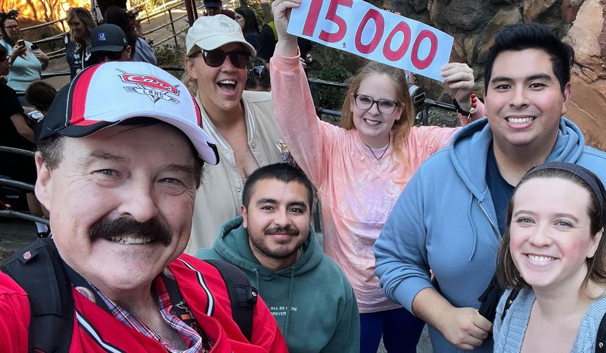In this photo provided by Jon Alan Hale, Hale, left, poses with friends after taking his 15,000th Radiator Springs Racers ride at Disney California Adventure in Anaheim, Calif., Monday, Dec. 8, 2025. (Jon Alan Hale via AP)