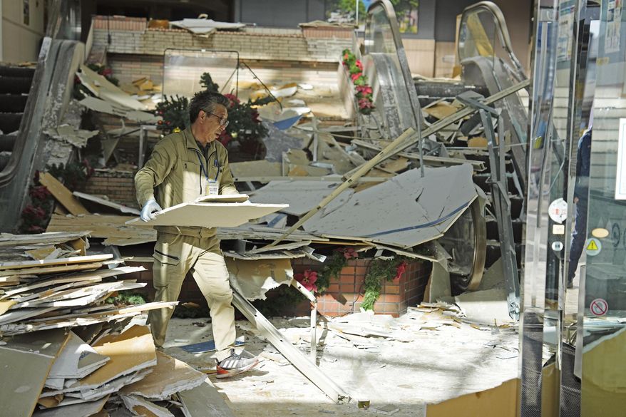A man clears the debris from a powerful earthquake at a commercial facility in Hachinohe, Aomori prefecture, northern Japan Tuesday, Dec. 9, 2025. (Ren Onuma/Kyodo News via AP)