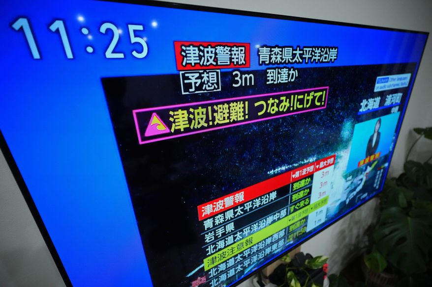 A tsunami warning is displayed on a television in Yokohama, near Tokyo, Monday, Dec. 8, 2025, after a strong earthquake hits off Japanese northern coast, tsunami alert issued. (AP Photo/Eugene Hoshiko)