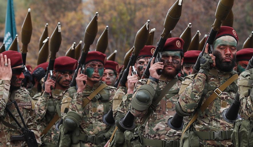 Fighters from the new Syrian army march with rocket-propelled grenade launchers during a parade marking the first anniversary of the ousting of former President Bashar Assad in Damascus, Syria, Monday, Dec. 8, 2025. (AP Photo/Omar Sanadiki)