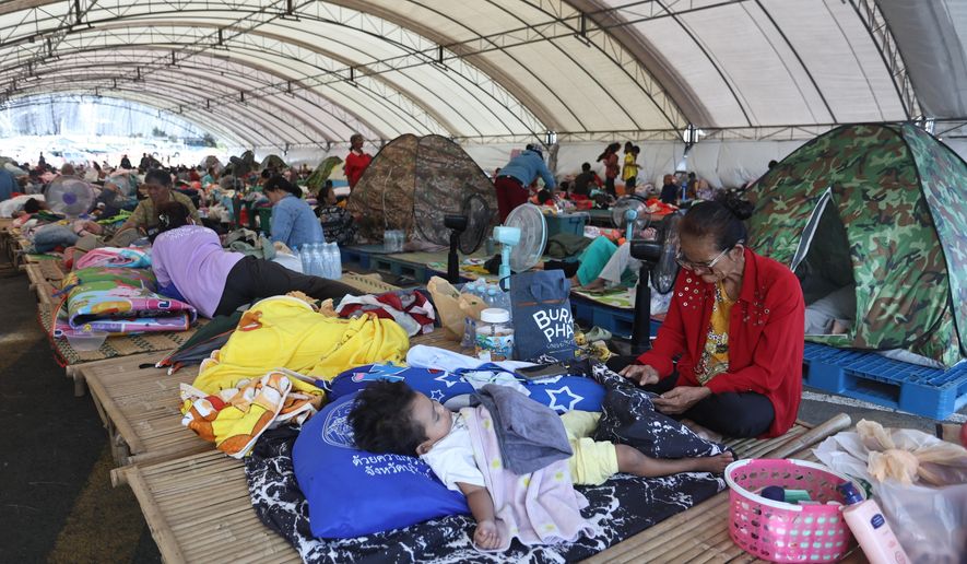 Thai residents who fled homes as Thailand and Cambodia clash over border, rest at an evacuation center in Buriram province, Thailand, Monday, Dec. 8, 2025. (AP Photo/Sopa Saelee)