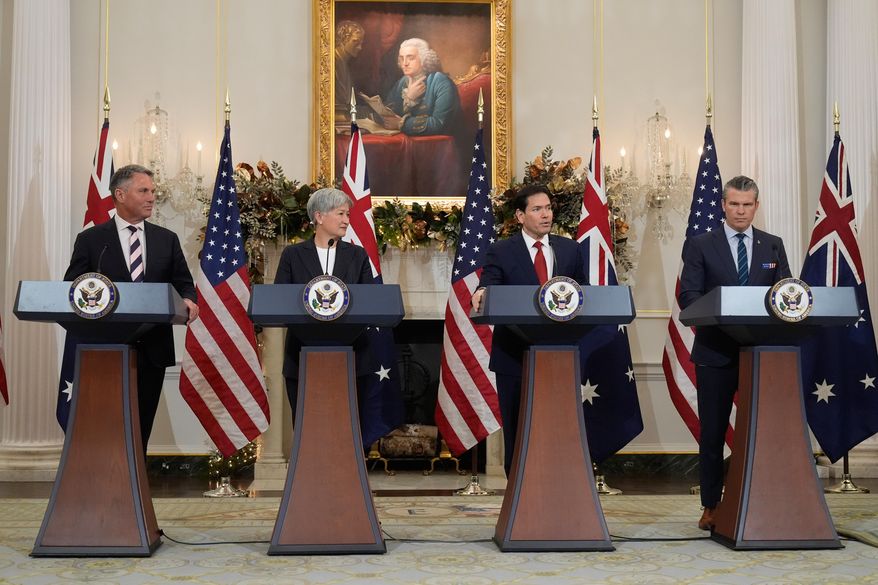 Secretary of State Marco Rubio speaks as Australia's Deputy Prime Minister and Defense Minister Richard Marles (from left), Australia's Foreign Minister Penny Wong and Defense Secretary Pete Hegseth listen at the State Department, Monday, Dec. 8, 2025, in Washington. (AP Photo/Mark Schiefelbein)