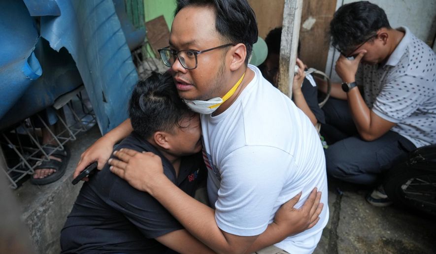 A man cries at the site of a fire in Jakarta, Indonesia, Tuesday, Dec. 9, 2025. (AP Photo/Dita Alangkara)