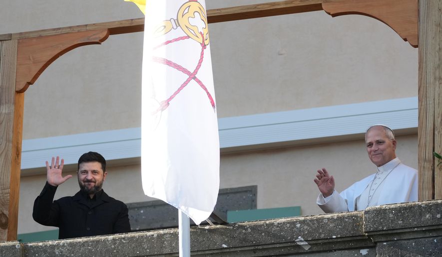 Ukraine's President Volodymyr Zelenskyy and Pope Leo XIV wave to journalists during their meeting in Castel Gandolfo, Italy, Tuesday, Dec. 9, 2025. (AP Photo/Andrew Medichini)