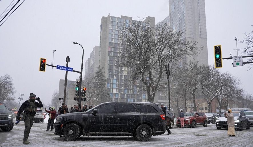 Activists confronted a group of Immigration and Customs Enforcement officers in the largely Somali neighborhood of Cedar-Riverside in Minneapolis on Tuesday, Dec. 9, 2025. (AP Photo/Mark Vancleave) **FILE**