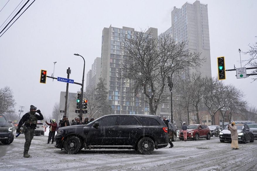 Activists confronted a group of Immigration and Customs Enforcement officers in the largely Somali neighborhood of Cedar-Riverside in Minneapolis on Tuesday, Dec. 9, 2025. (AP Photo/Mark Vancleave) **FILE**