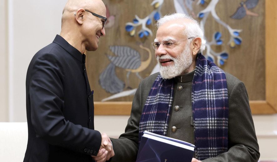 In this handout photo provided by Microsoft, Chief Executive Officer Satya Nadella, left, shakes hands with Indian Prime Minister Narendra Modi during their meeting in New Delhi, India, Tuesday, Dec. 9, 2025. (Microsoft via AP)