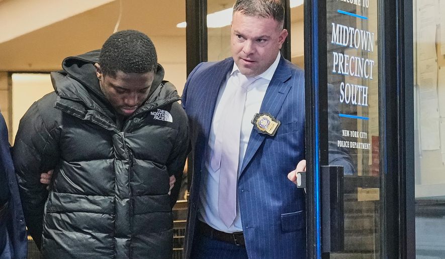Frederick Green, 20, of The Bronx borough of New York, charged with attempted murder in the shooting of New York Jets' player Kris Boyd, is escorted from the Midtown South Police Precinct, in New York, Tuesday, Dec. 9, 2025. (AP Photo/Richard Drew)
