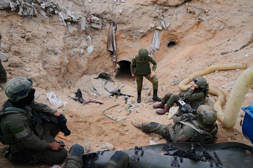 Israeli soldiers stand at the entrance of a tunnel where the army says the body of soldier Hadar Goldin was held in Rafah, Gaza Strip, Monday, Dec. 8, 2025. Hamas returned his remains to Israel as part of the current ceasefire. (AP Photo/Sam Mednick)