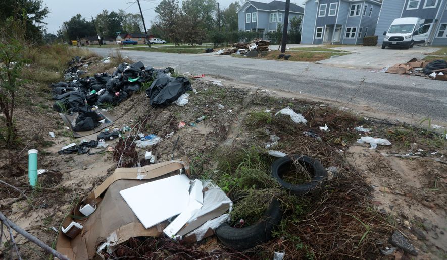 Piles of trash fill the ditch across a construction site in the Trinity Gardens neighborhood in northwest Houston, Thursday, Dec. 4, 2025. (AP Photo/Lekan Oyekanmi )