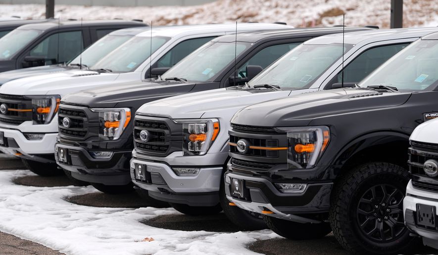 FILE - Unsold 2024 F150 pickup trucks sit in a long row at a Ford dealership Sunday, Jan. 21, 2024, in Broomfield, Colo. (AP Photo/David Zalubowski, File)
