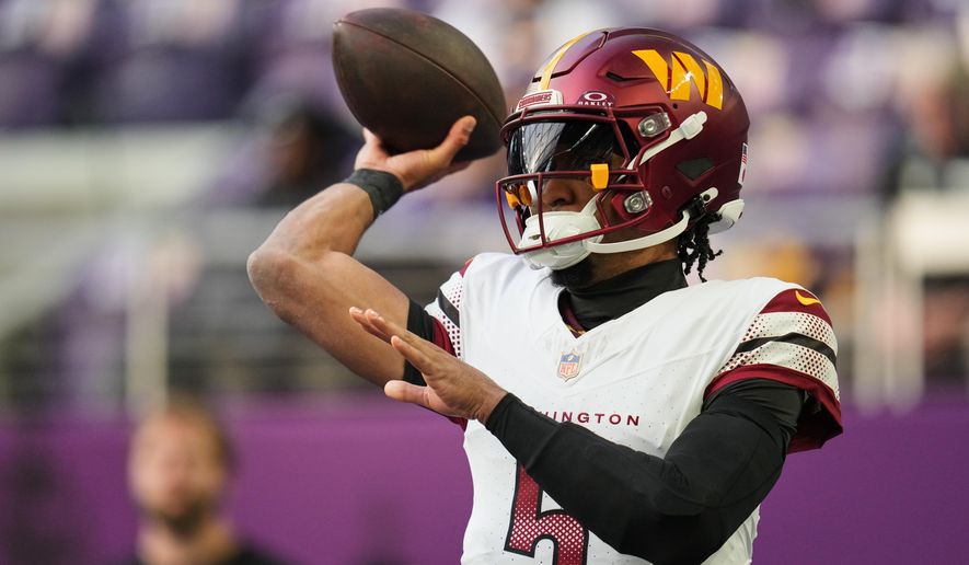 Washington Commanders quarterback Jayden Daniels warms up before an NFL football game against the Minnesota Vikings, Sunday, Dec. 7, 2025, in Minneapolis. (AP Photo/Abbie Parr)