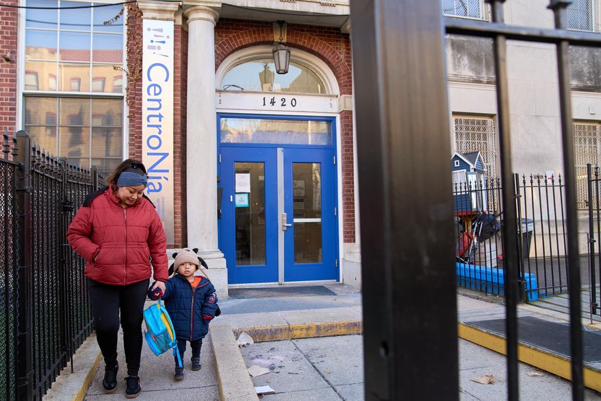 Families leave CentroNia at the end of the school day in Washington, Tuesday, Dec. 9, 2025. (AP Photo/Jacquelyn Martin)