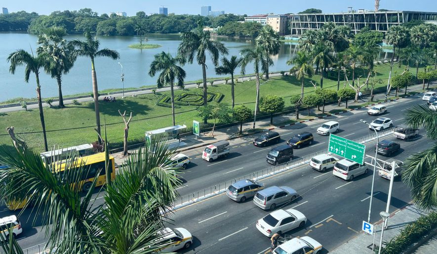 A high-angle view of a busy road with famous Inya Lake in the background in Yangon, Myanmar, Wednesday, Dec. 10, 2025. (AP Photo)