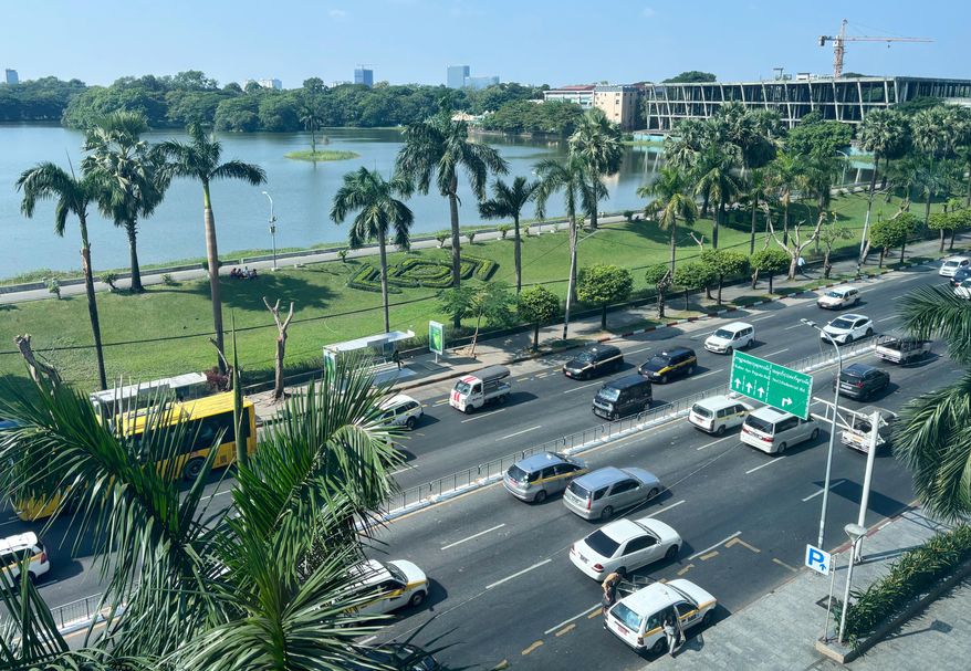 A high-angle view of a busy road with famous Inya Lake in the background in Yangon, Myanmar, Wednesday, Dec. 10, 2025. (AP Photo)