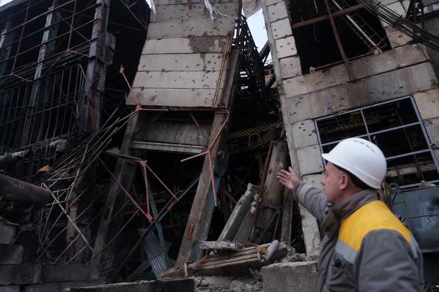 A worker shows damages of a production hall after a recent Russian missile attack at DTEK's power plant in Ukraine, on Wednesday, Dec. 10, 2025. (AP Photo/Evgeniy Maloletka)