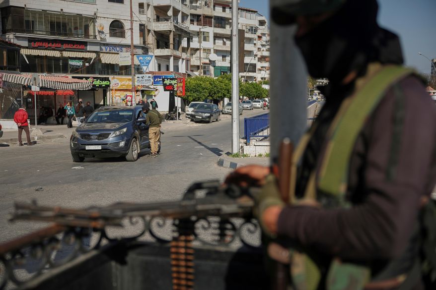 Syrian security forces inspect vehicles at a checkpoint, following a recent wave of violence between Syrian security forces and gunmen loyal to former President Bashar Assad, as well as subsequent sectarian attacks, in Latakia, in Syria's coastal region, March 11, 2025. (AP Photo/Ghaith Alsayed, File)