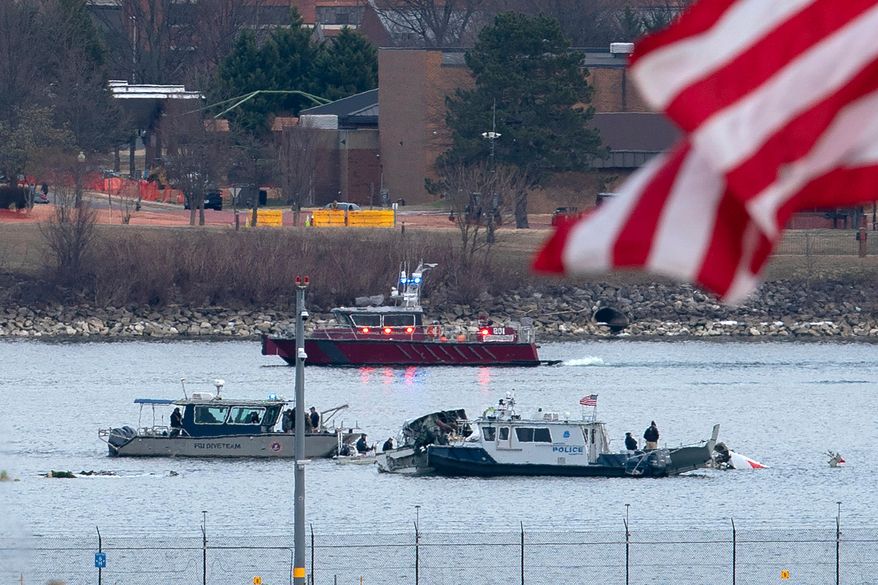 A diving team and police boat is seen near a wreckage site in the Potomac River, from Ronald Reagan Washington National Airport, Jan. 30, 2025, in Arlington, Va. (AP Photo/Jose Luis Magana, File)