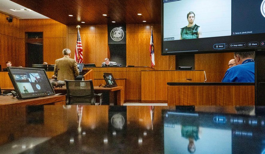 Defense attorney Greg Skordas, left, speaks before Judge Tony Graf, background, in Provo, Utah, as Tyler Robinson, in monitor at right, accused of fatally shooting Charlie Kirk, attends the court hearing virtually from prison on Tuesday, Sept. 16, 2025. (Scott G Winterton/The Deseret News via AP, Pool, File)