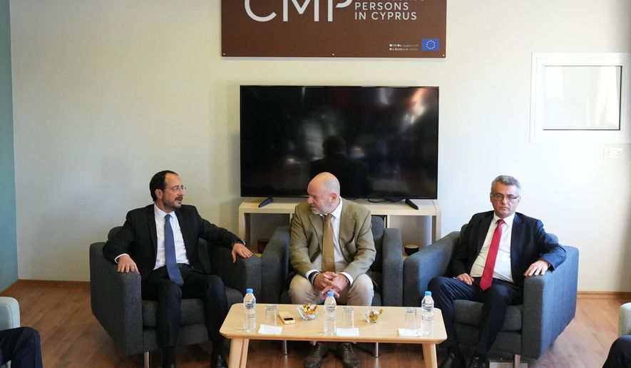 Cyprus President Nikos Christodoulides, left, and Turkish Cypriot leader Tufan Erhurman, right, meet with the UN third member of the tripartite Committee on Missing Persons in Cyprus Pierre Gentile at a U.N compound inside the UN-controlled buffer zone in the island's divided capital Nicosia, on Thursday, Dec. 11. 2025. (AP Photo/Petros Karadjias, Pool)