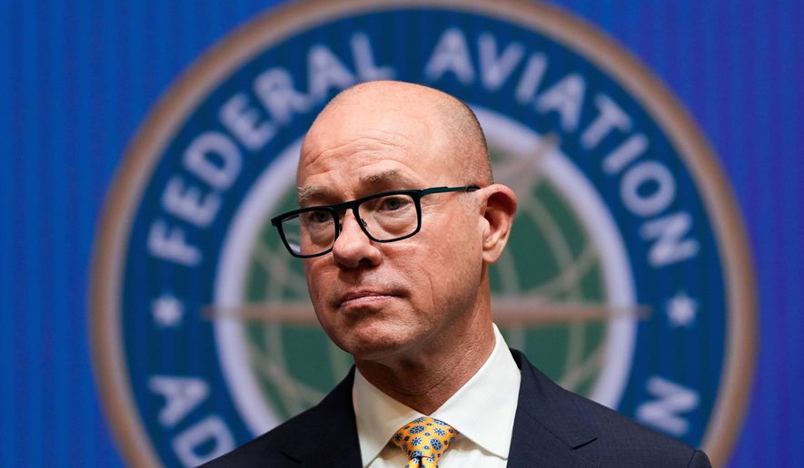 FILE - Federal Aviation Administration administrator Bryan Bedford looks on as Transportation Secretary Sean Duffy speaks during a news conference on new drone regulations, Aug. 5, 2025, at the Department of Transportation in Washington. (AP Photo/Julia Demaree Nikhinson, File)