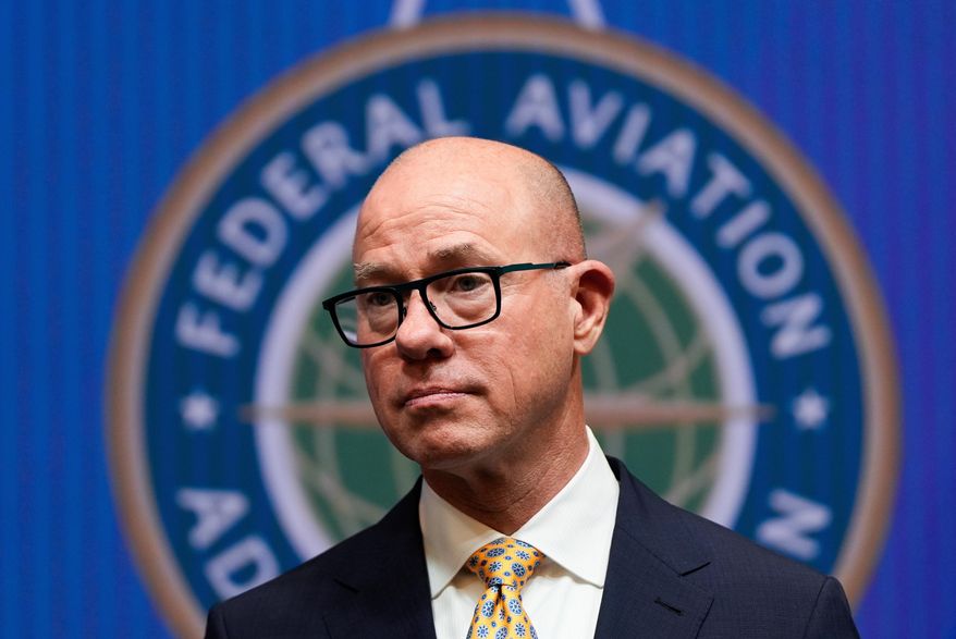 FILE - Federal Aviation Administration administrator Bryan Bedford looks on as Transportation Secretary Sean Duffy speaks during a news conference on new drone regulations, Aug. 5, 2025, at the Department of Transportation in Washington. (AP Photo/Julia Demaree Nikhinson, File)