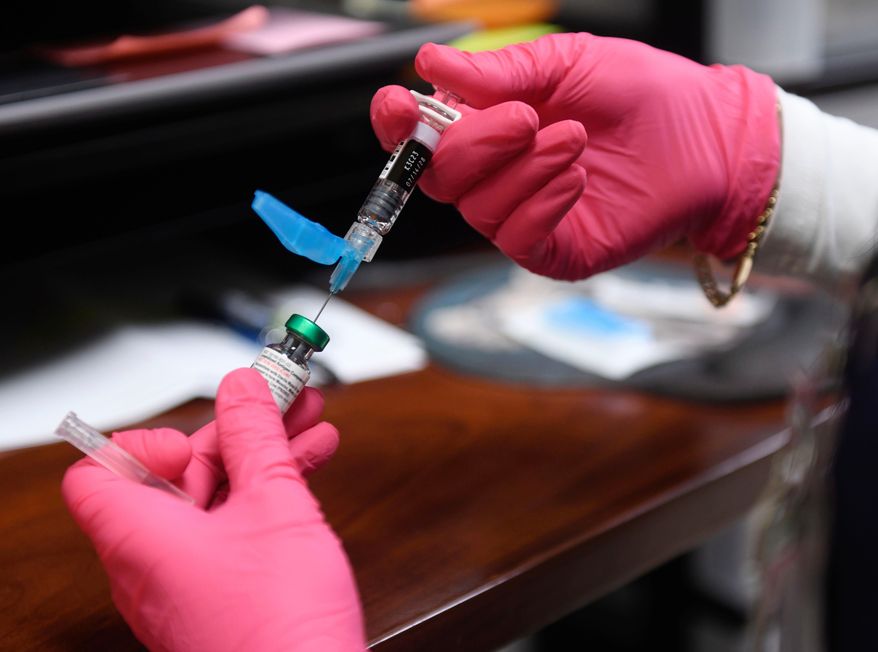 Anna Hicks prepares a measles, mumps and rubella vaccine. (AP Photo/Annie Rice, File)