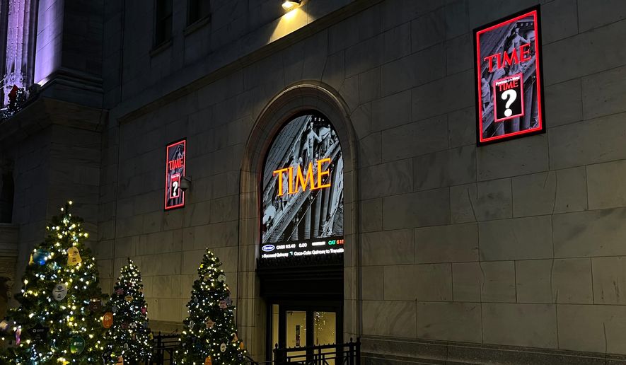 A sign for Time magazine is displayed outside the New York Stock Exchange on Thursday, Dec. 11, 2025 in New York. (AP Photo/Donald King)