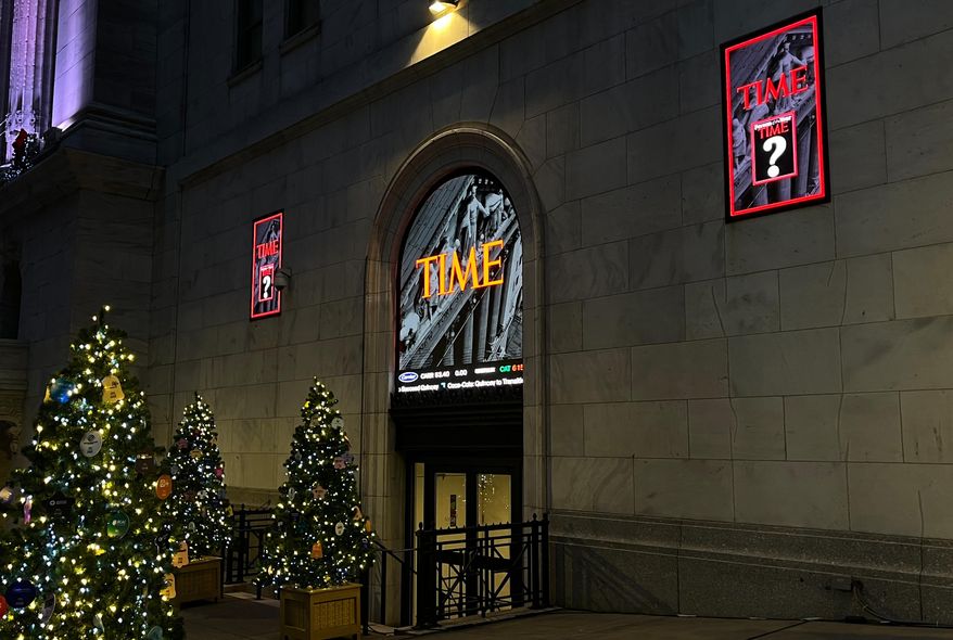 A sign for Time magazine is displayed outside the New York Stock Exchange on Thursday, Dec. 11, 2025 in New York. (AP Photo/Donald King)