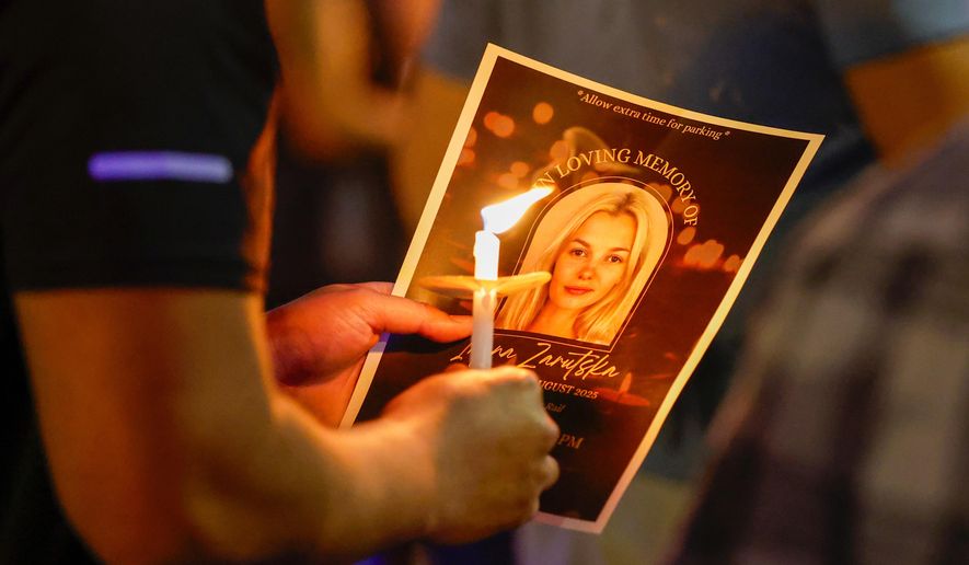 Community members gather for a vigil honoring the life of Iryna Zarutska, a Ukranian refugee, who was fatally stabbed on a commuter train, Sept. 22, 2025, in Charlotte, N.C. (AP Photo/Nell Redmond, File)