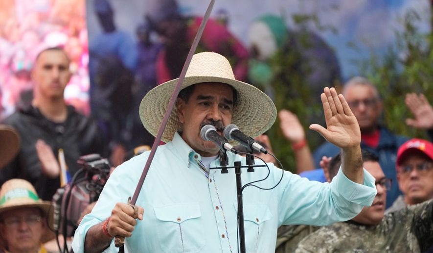 President Nicolas Maduro addresses supporters during a rally marking the anniversary of the Battle of Santa Ines, which took place during Venezuela's 19th-century Federal War, in Caracas, Venezuela, Wednesday, Dec. 10, 2025. (AP Photo/Ariana Cubillos)